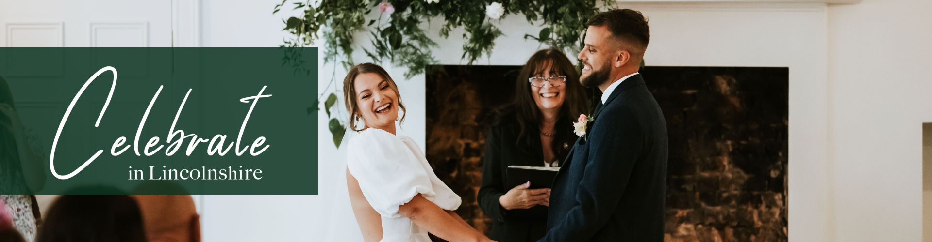 A wedding groom and bride holding hands at the ceremony in front of the celebrant