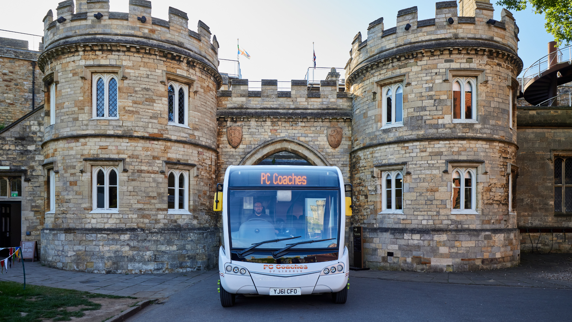 A bus travels through the arches at Lincoln Castle