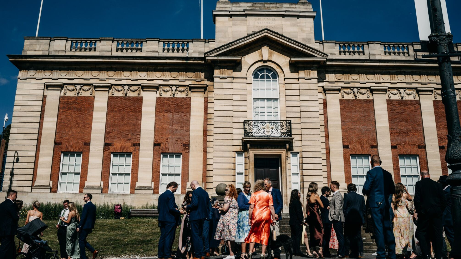 Usher Gallery front entrance of the outside building, with wedding party gathering outside