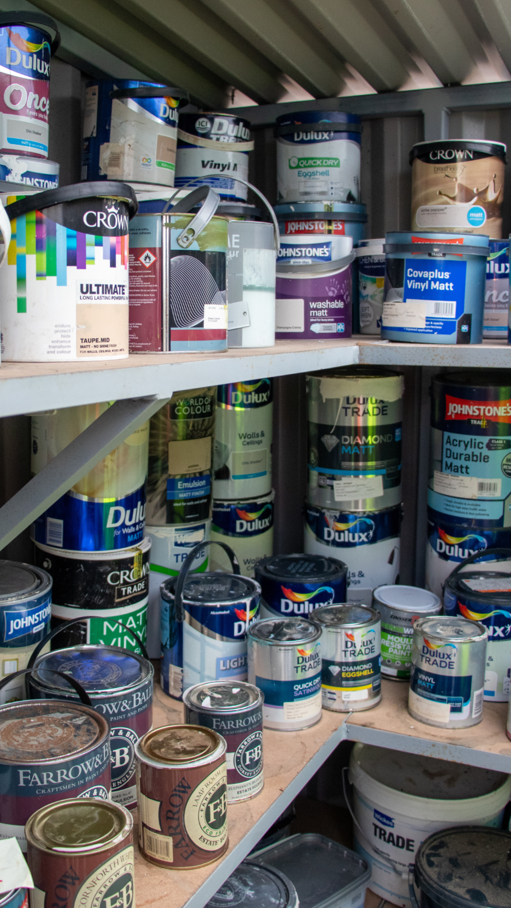 Tins of paint lined up on shelves