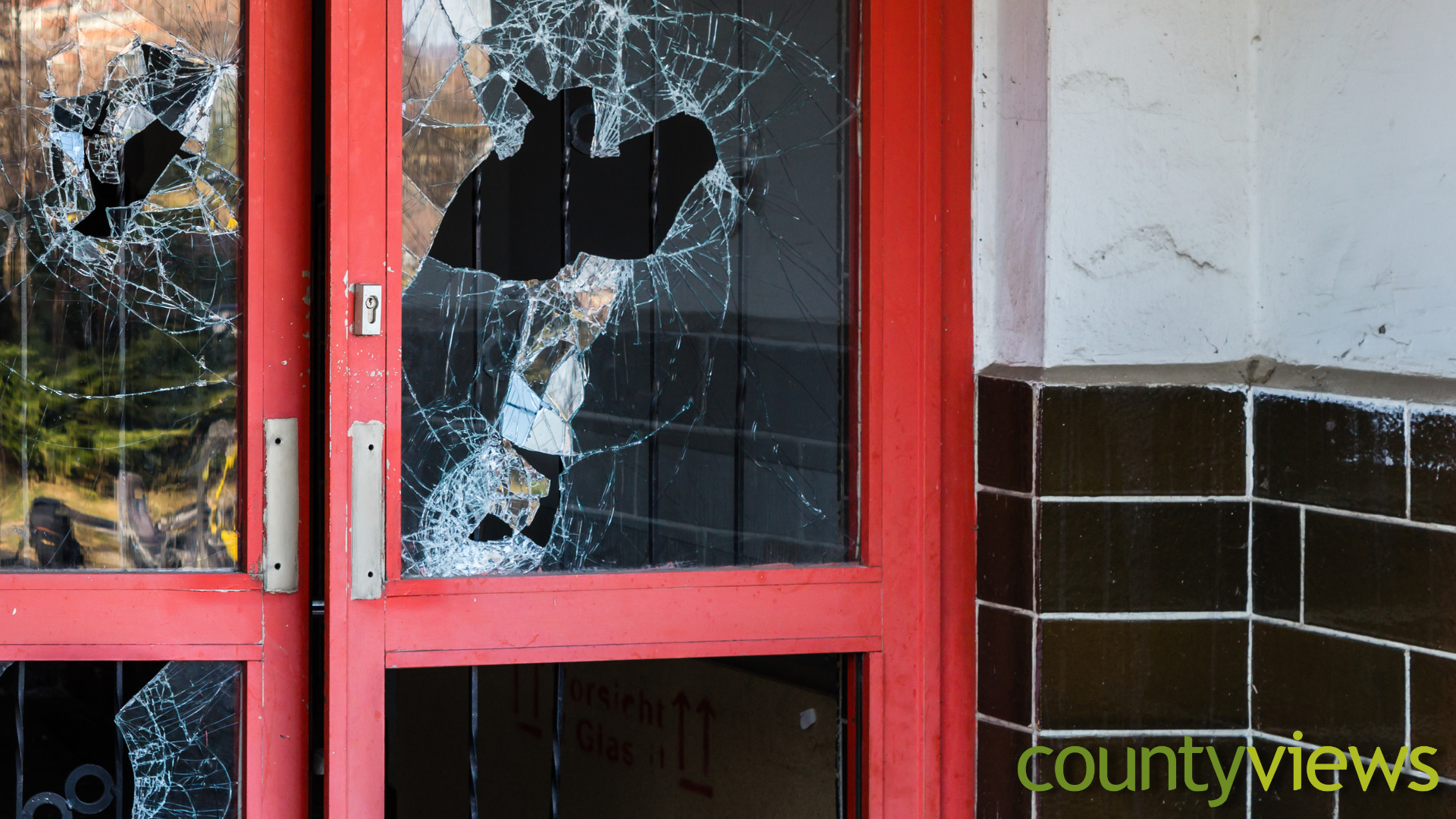 A smashed door next to the County Views logo