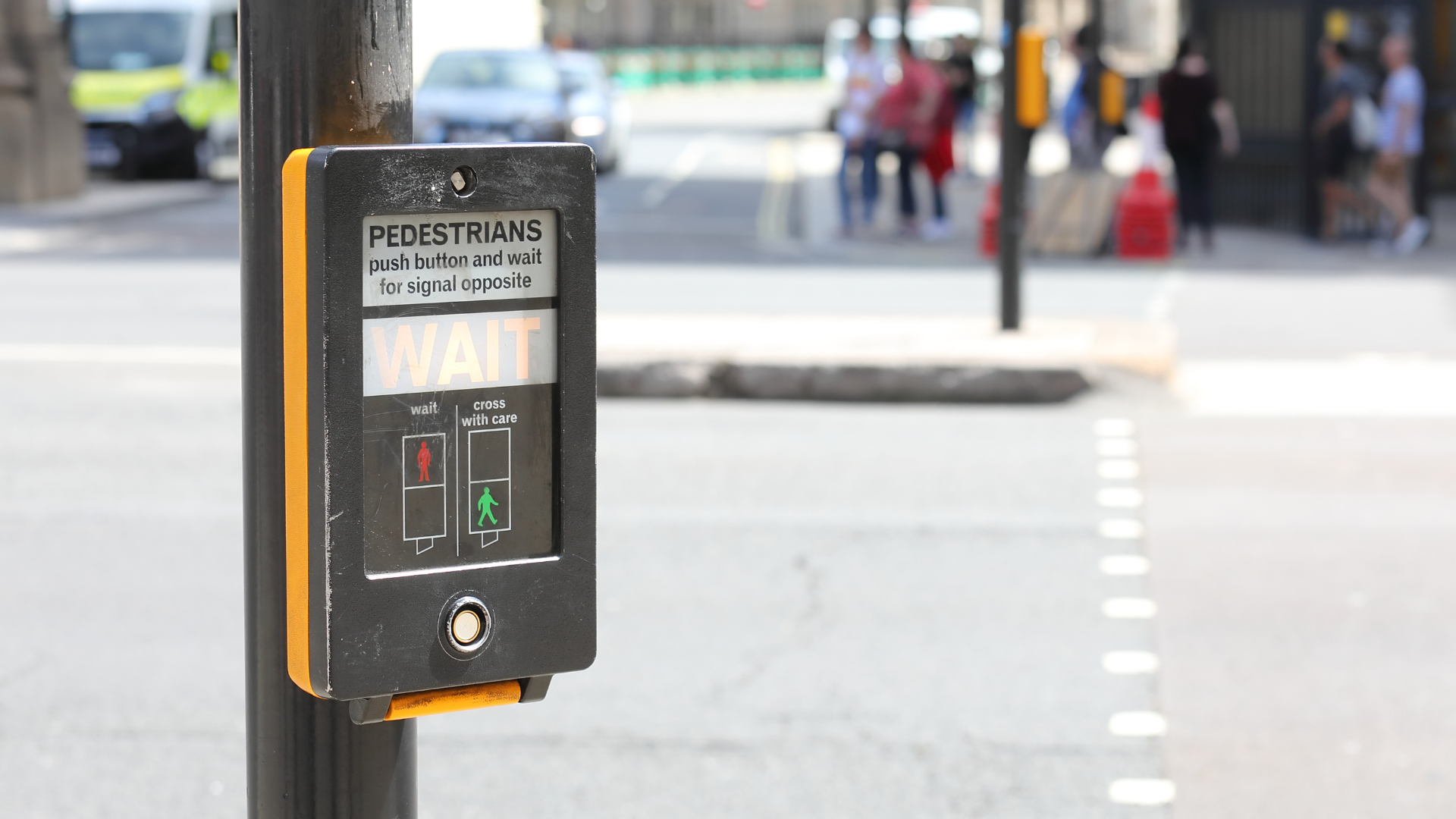 A close up of a pedestrian crossing button