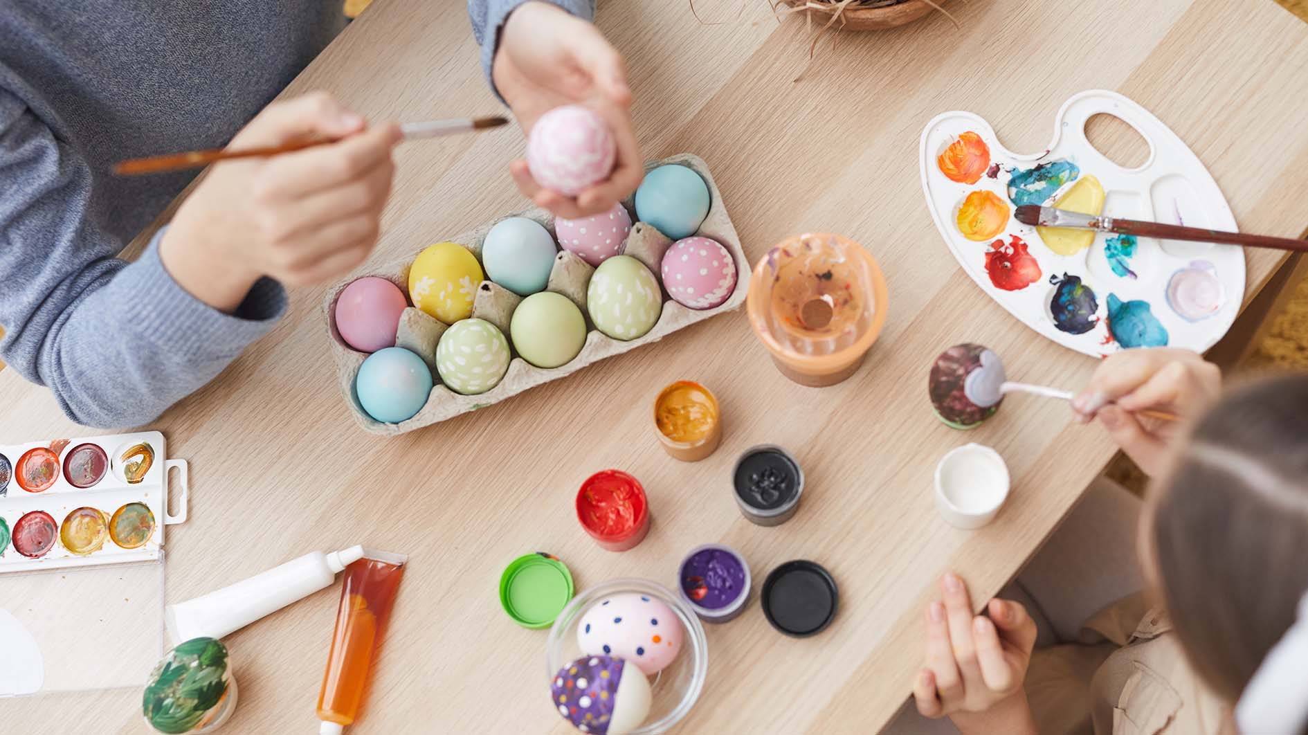Children paint eggs for Easter