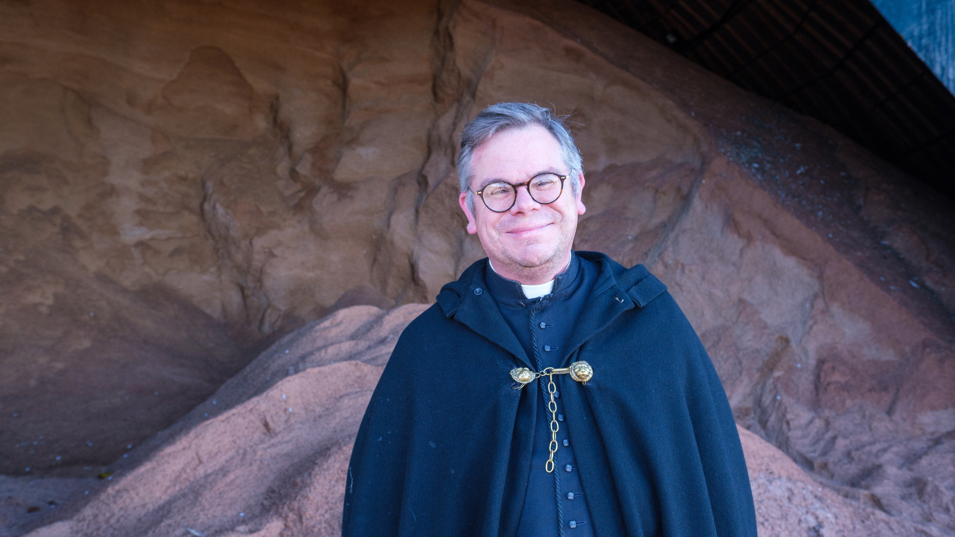 Father Cradduck in front of pile of salt