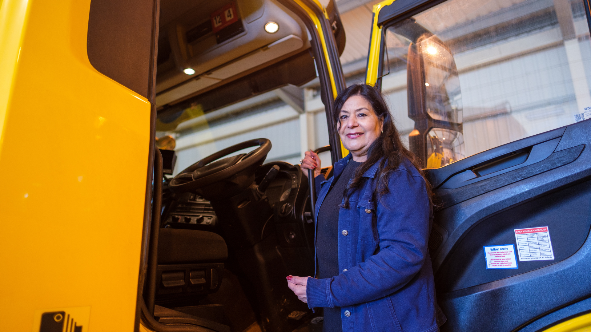 Nina Chapman standing on ladder to gritter cab