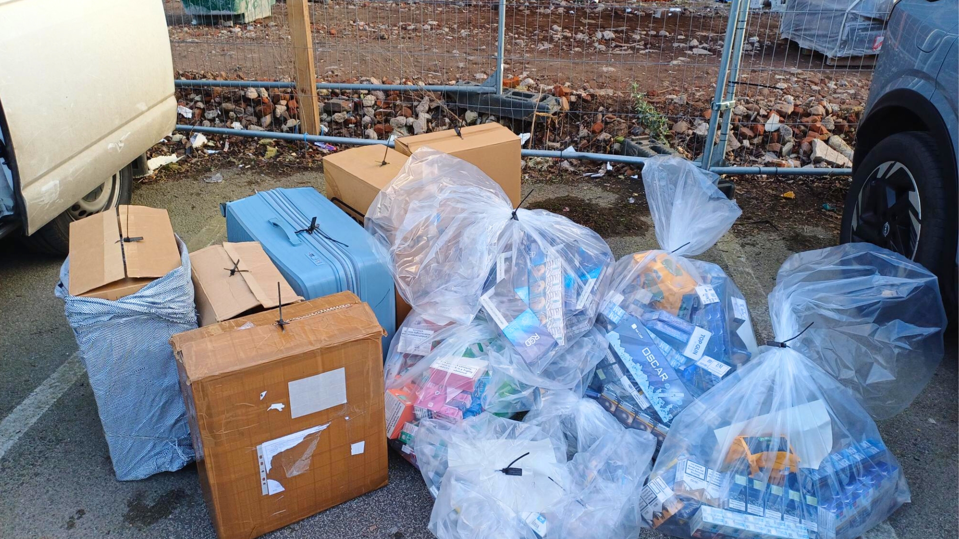 Bags, suitcases and cardboard boxes containing seized illegal cigarettes