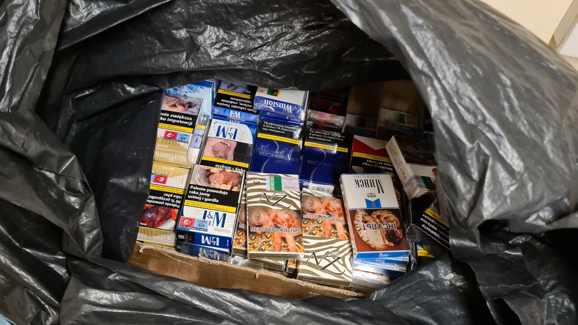 Illegal cigarette boxes in a black bin bag