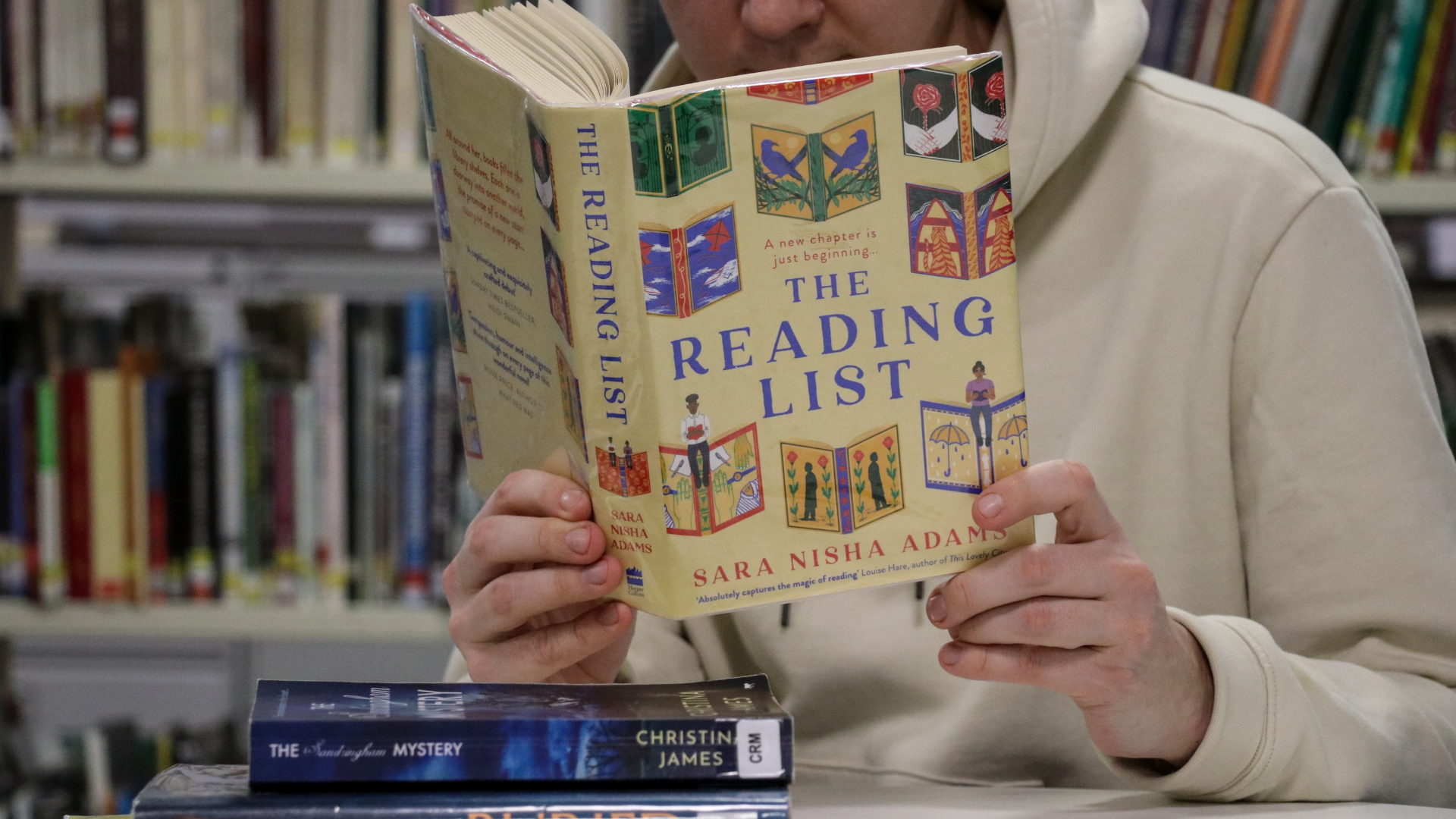 A man reading a book in a library