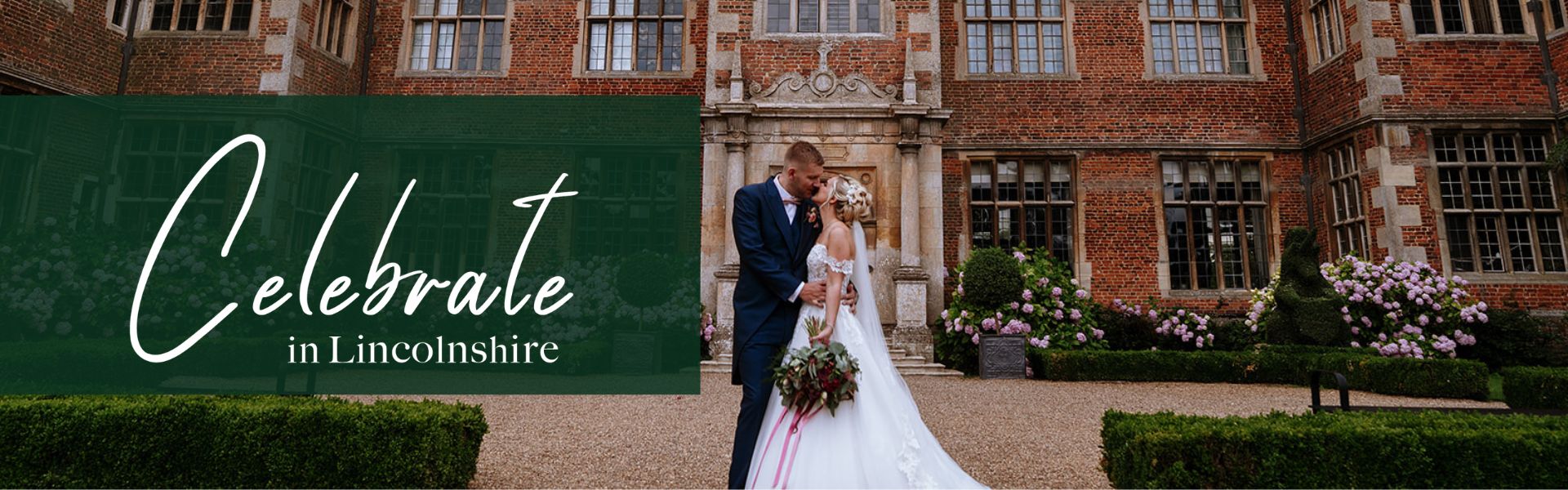 A bride and groom stood outside an old grand building