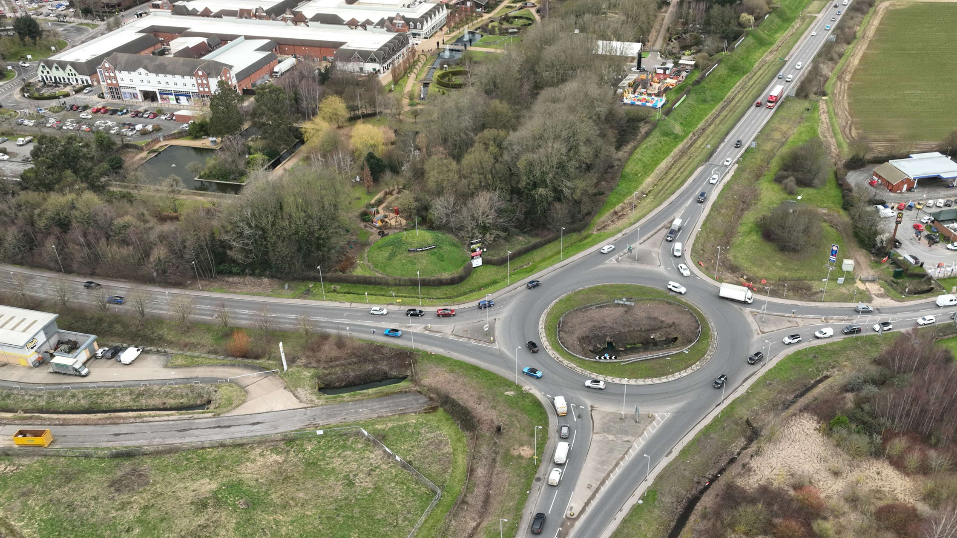 Air view of a roundabout surrounded by greenery
