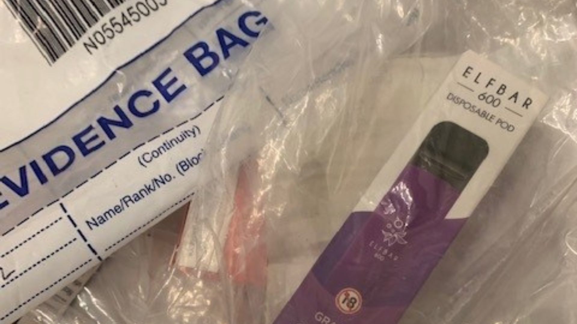 A grape elf bar vape in a bag next to an evidence bag
