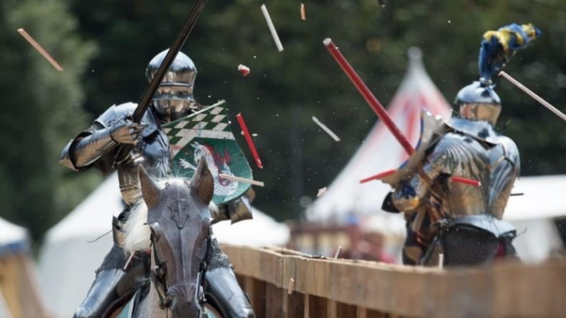 Two medieval knights on horseback jousting