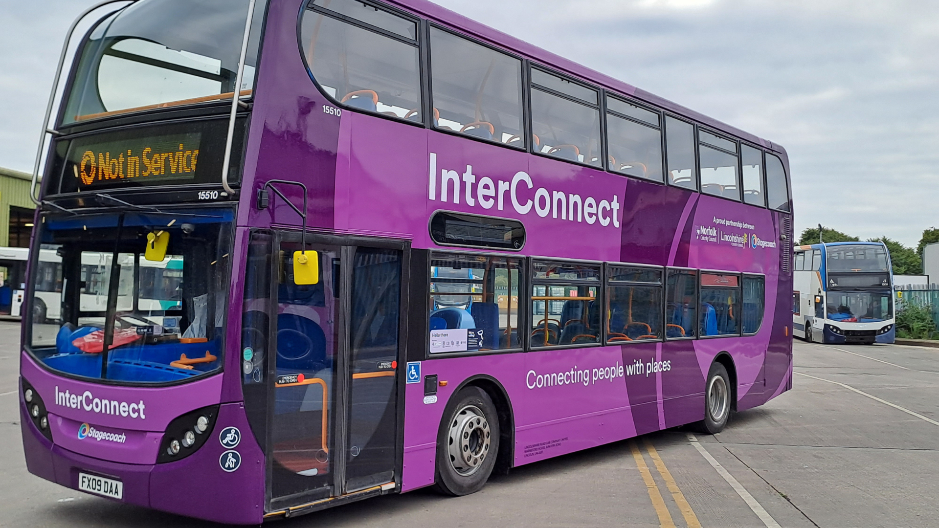A purple double decker bus