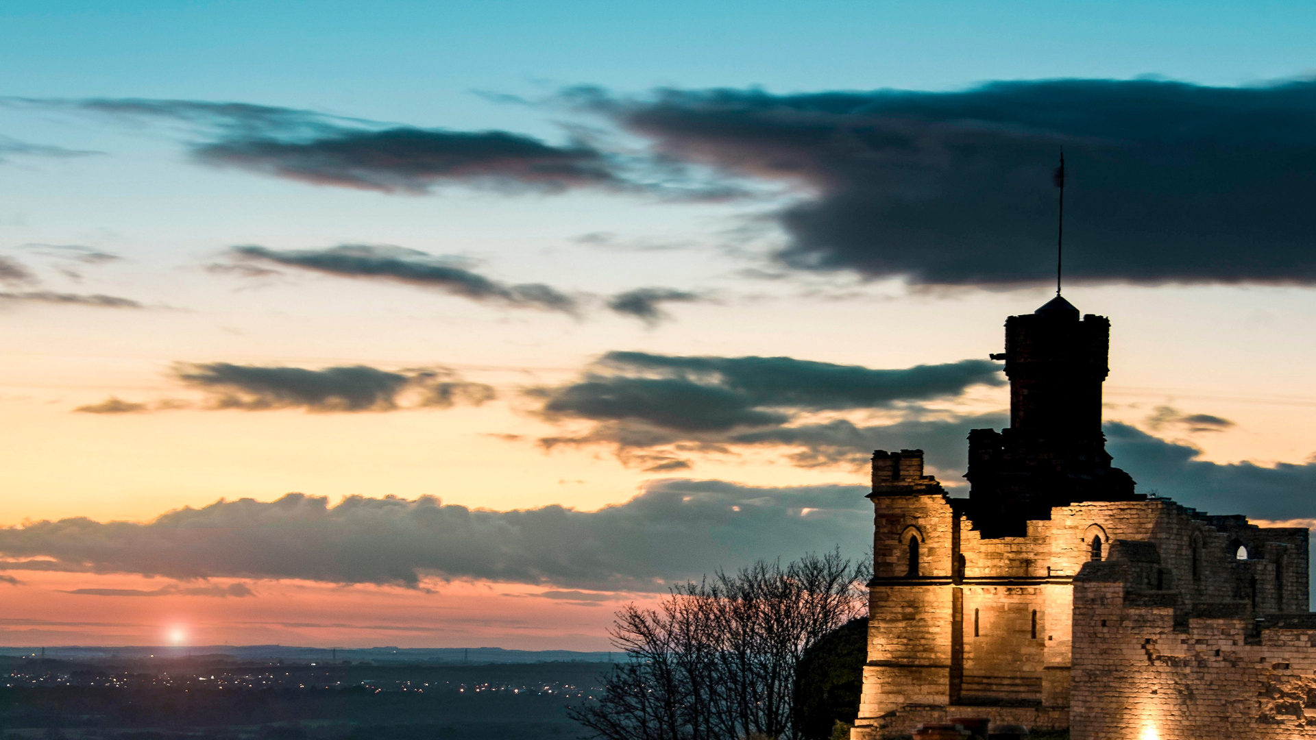 Castle tower silhouette with sunset behind