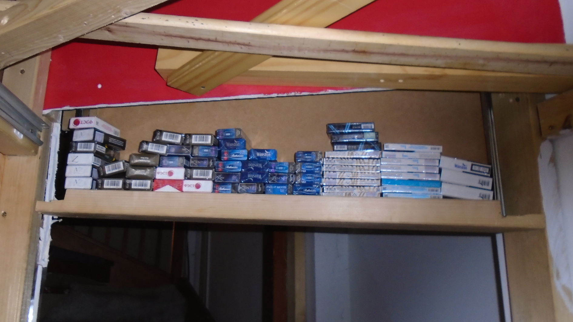 A cache of illegal cigarettes hidden above a doorway