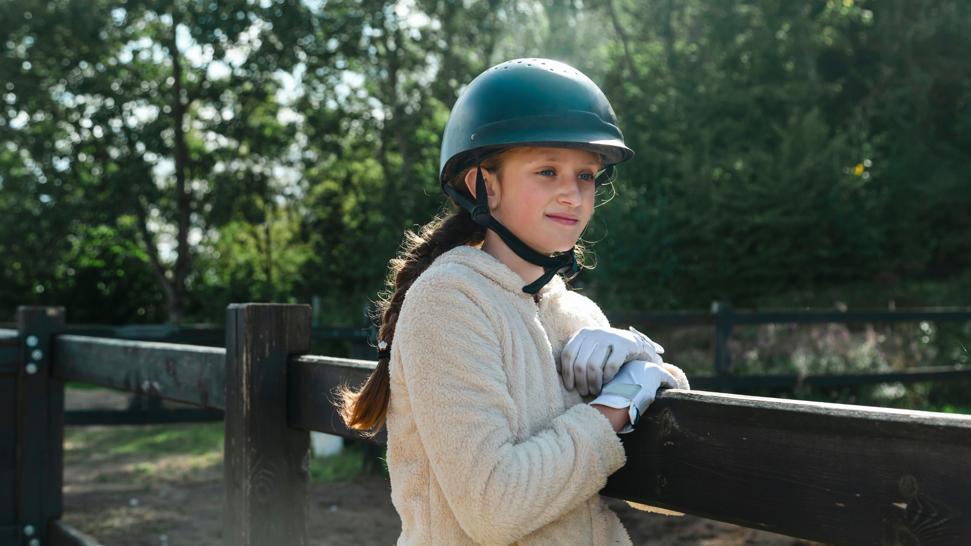 A young girl in horse riding clothing