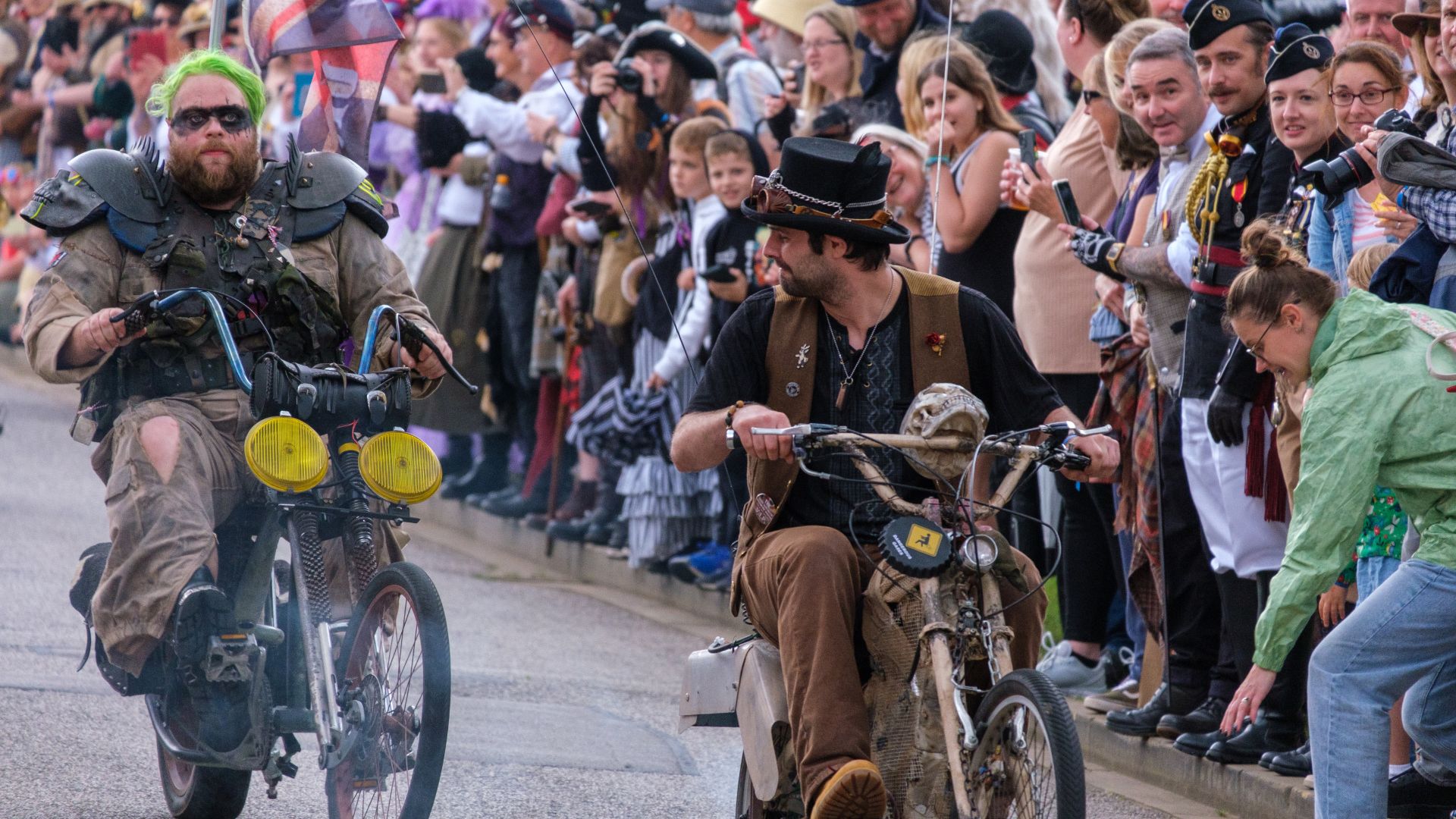 People dressed up in their Steampunk outfits on bikes